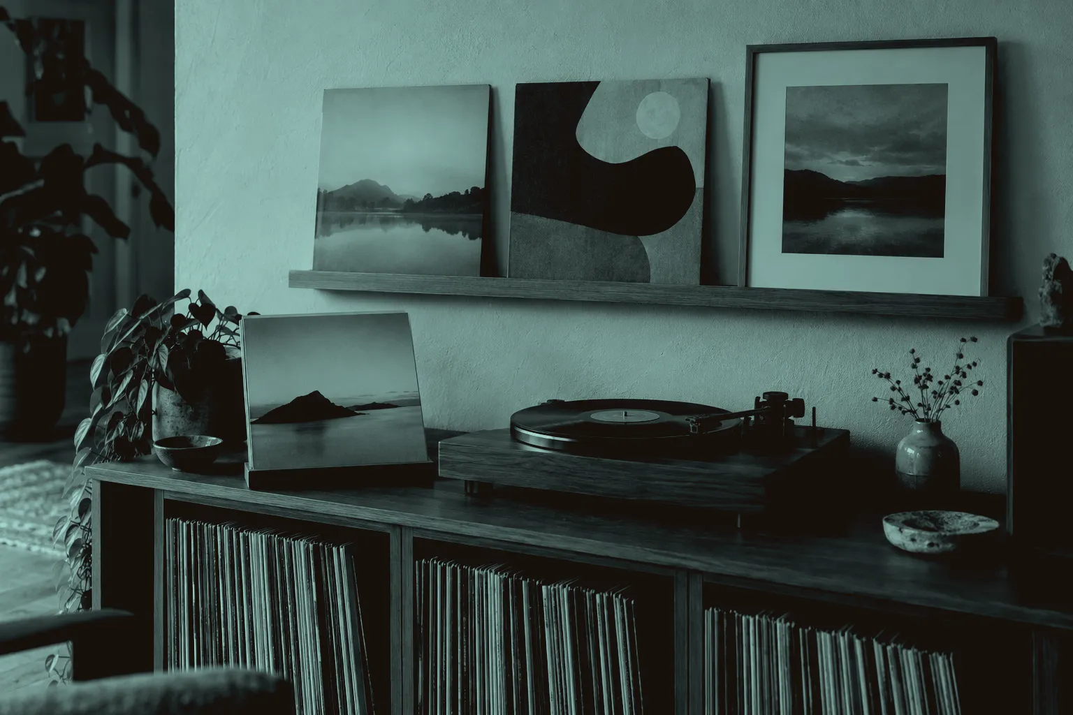 Record sleeves displayed on a picture ledge, in a frame and on a stand beside a turntable, with records stored upright below.