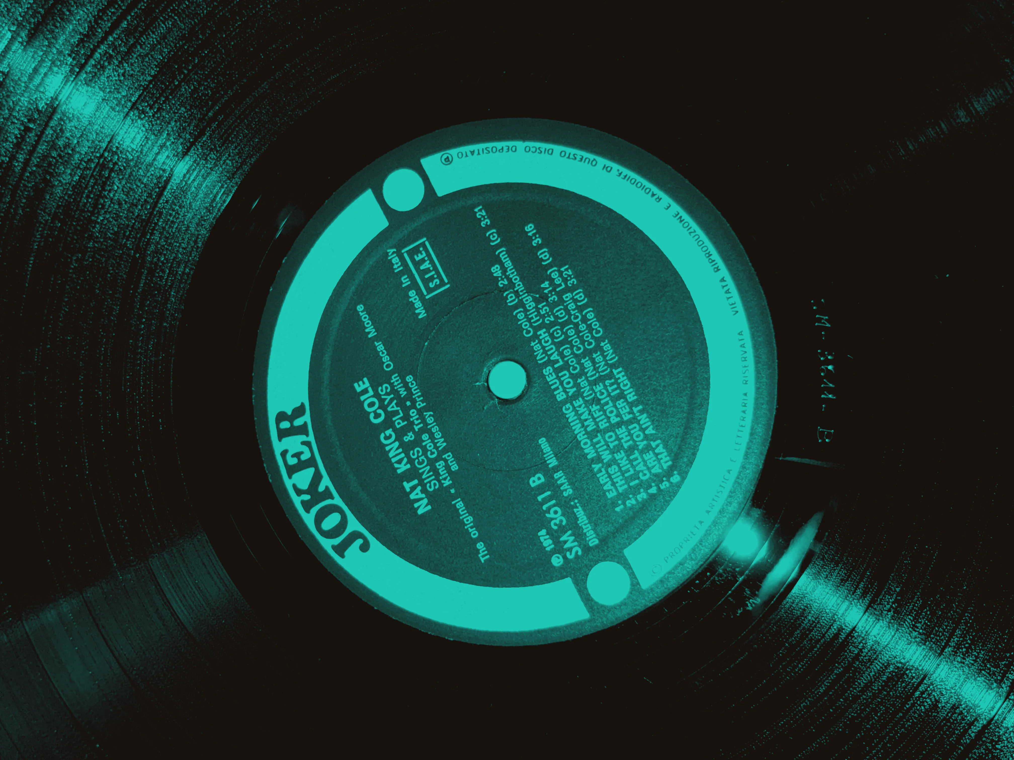 The runout beside the Joker label of an Italian pressing of Nat King Cole's Sings & Plays, showing the hand-etched matrix number SM-3611-B